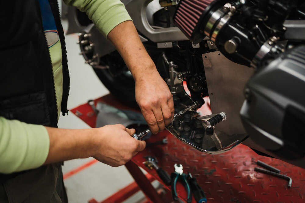 men-servicing-a-motorcycle-in-the-garage