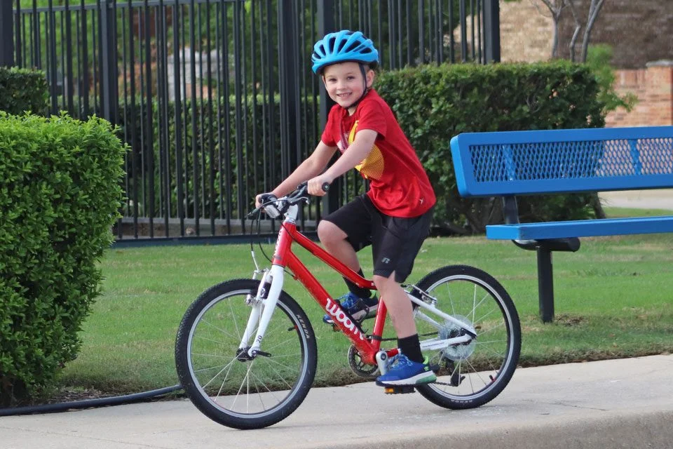 a small boy smiling while wearing giro hale mips bike helmet