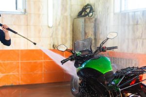 বাইকের যত্ন - washing green motorcycle